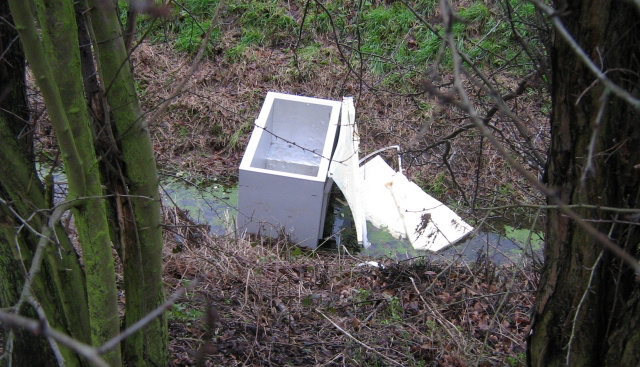 Fridge or freezer left in a ditch.