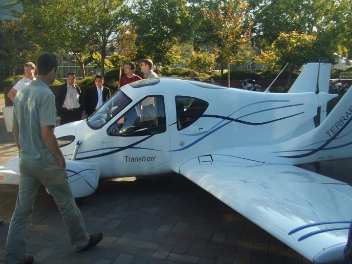 Terrafugia's flyable prototype Transition airplane, later assigned tail number N302TF, being shown during SciFoo 2008 at Google's headquarters in Mountain View, California. Just behind the airplane are two of Terrafugia's founders: Samuel Schweighart (L, red shirt), VP of Engineering; and Carl Dietrich (R, beige shirt), CEO/CTO.