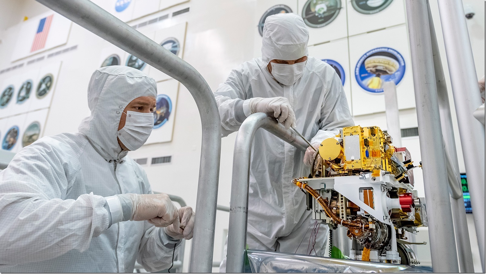 In this image taken June 25, 2019, engineers install the SuperCam instrument on Mars 2020's rover. This image was taken in the Spacecraft Assembly Facility at NASA's Jet Propulsion Laboratory, Pasadena, California. Credits: NASA/JPL-Caltech