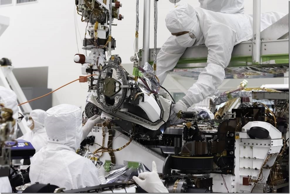 The bit carousel, which lies at the heart of Sample Caching System of NASA's Mars 2020 mission, is attached to the front end of the rover in the Spacecraft Assembly Facility's High Bay 1 at the Jet Propulsion Laboratory in Pasadena, California. The carousel contains all of the tools the coring drill uses to sample the Martian surface and is the gateway for the samples to move into the rover for assessment and processing. Credits: NASA
